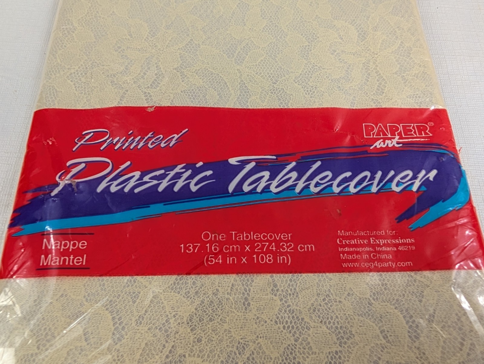 Creative Expression Paper Art Printed Lace Plastic Tablecover 54″x108″ NIP Cream